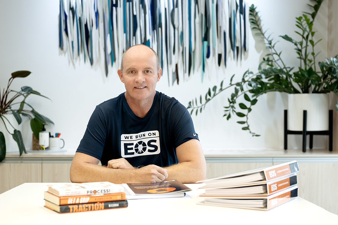 Steve Krebs, Professional EOS Implementer, at his desk with EOS materials